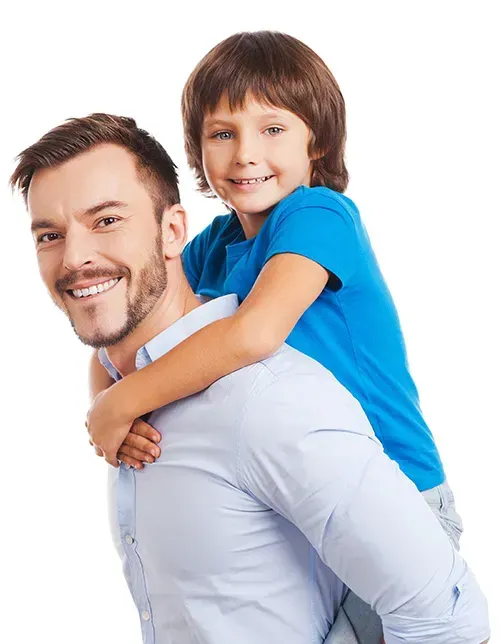 A man is carrying a little boy on his back.