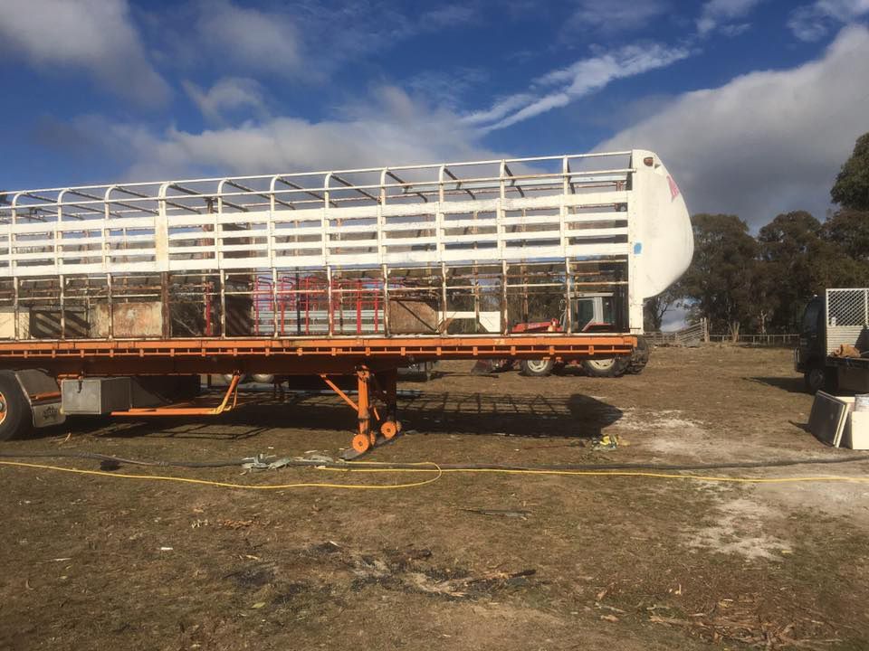 A Large Trailer Is Parked in A Field for Sand Blasting Restoration — ASSB Armidale Sand And Soda Blasting In Armidale, NSW