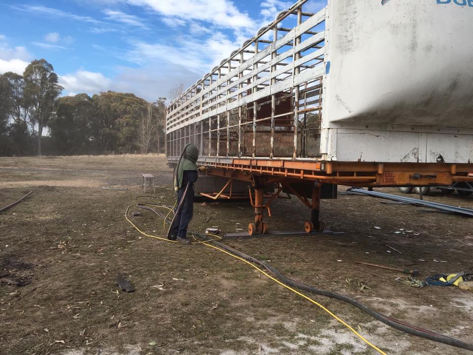 Man Worker Painting The Big Trailer — ASSB Armidale Sand And Soda Blasting In  Armidale, NSW