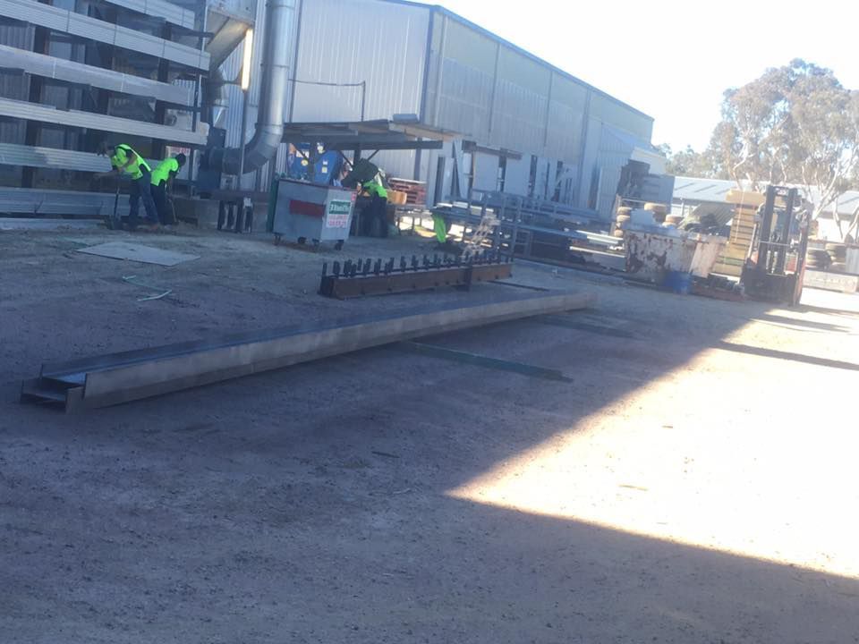 Men Workers In Green Uniforms With Working In Big Metal For Painting — ASSB Armidale Sand And Soda Blasting In Guyra, NSW 