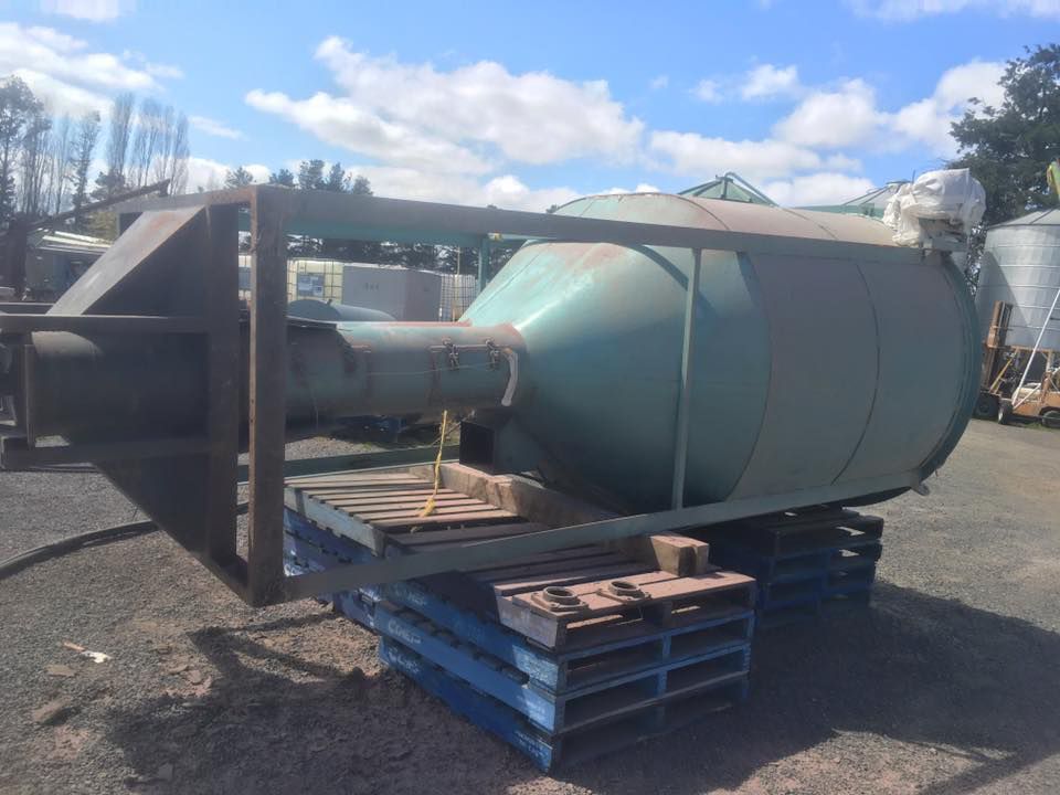 A Large Green Tank Is Sitting on Top of Pallets — ASSB Armidale Sand And Soda Blasting In Armidale, NSW