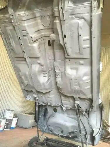 The Bottom of A Car Is Being Painted in A Garage — ASSB Armidale Sand And Soda Blasting In Tamworth, NSW