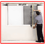 Man measuring a window's width and height with a tape measure. The window is in a white-walled room.