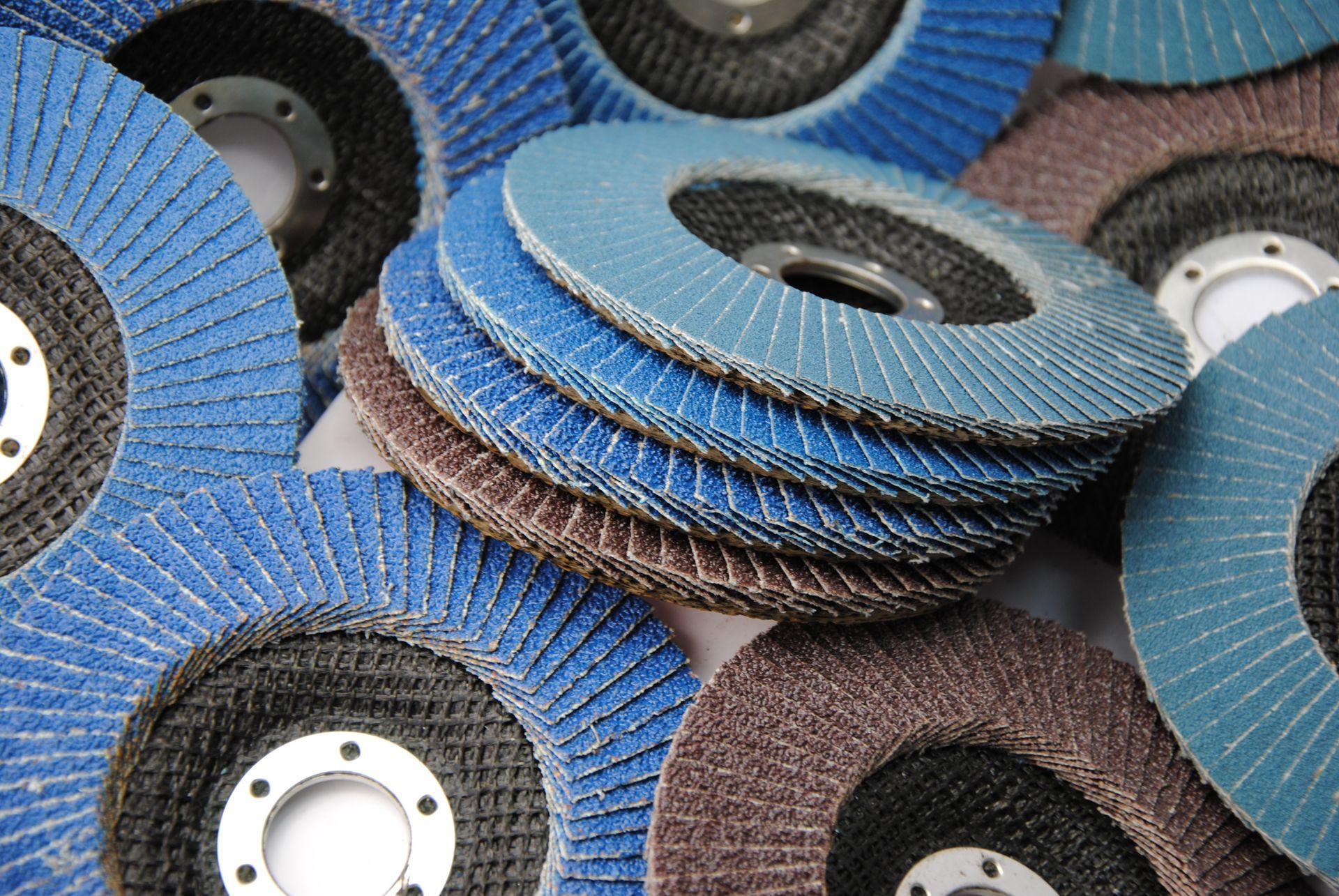 Close-up of a pile of stacked bonded abrasives grinding wheels.
