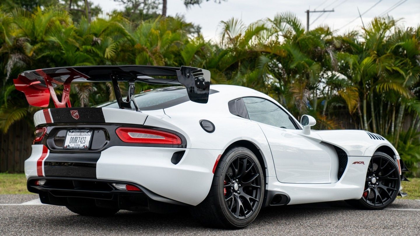 White Dodge Viper sports car with black and red accents, parked outdoors.