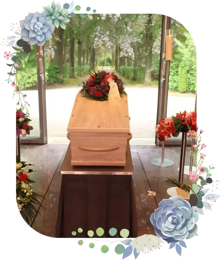 Wooden casket with red flowers in a garden-view funeral setting