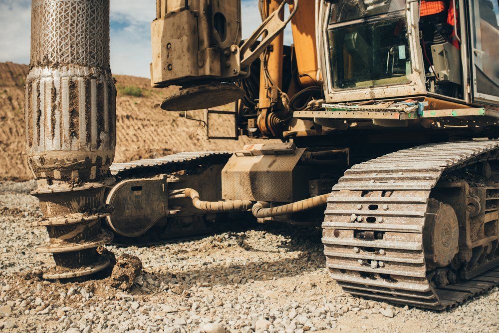 Rotary Drill Making Holes — Whitsunday Drainage Contractors in Cannonvale, QLD