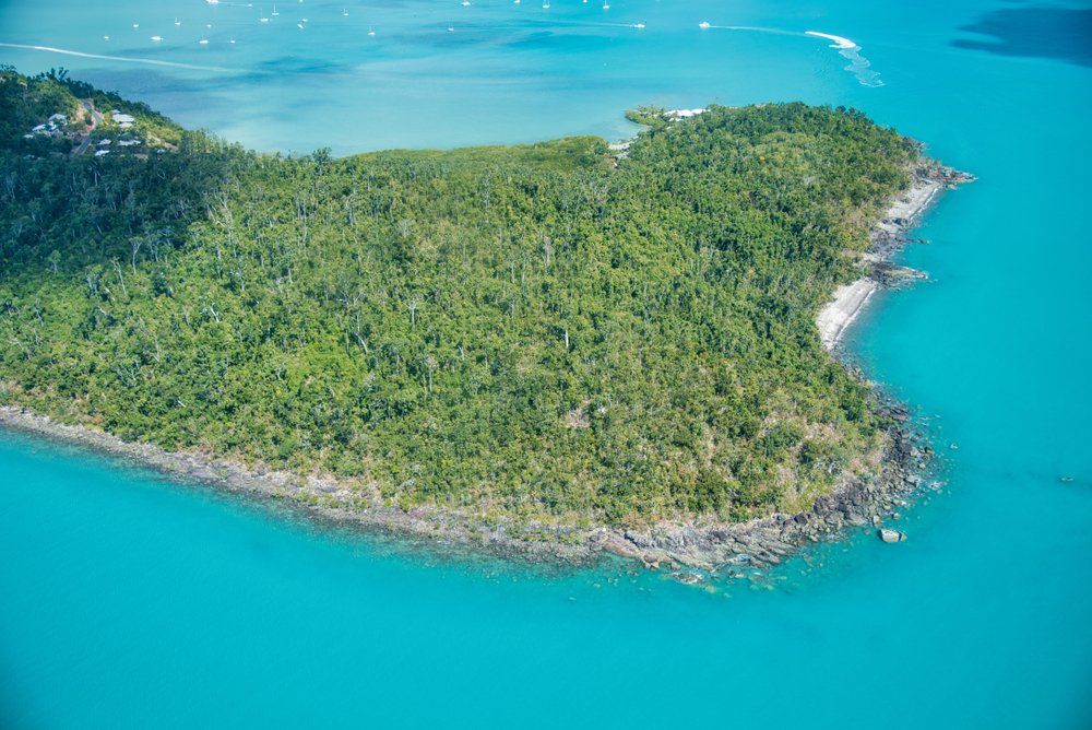 Aerial View of Airlie Beach Cannonvale Coastline, Australia — Whitsunday Drainage Contractors in Airlie Beach, QLD