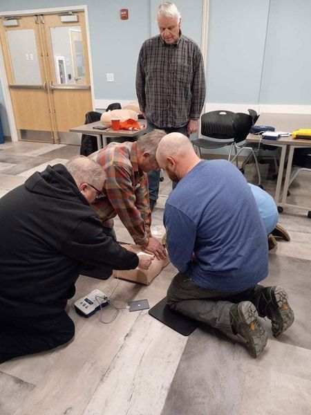 A group of men are kneeling on the floor in a room
