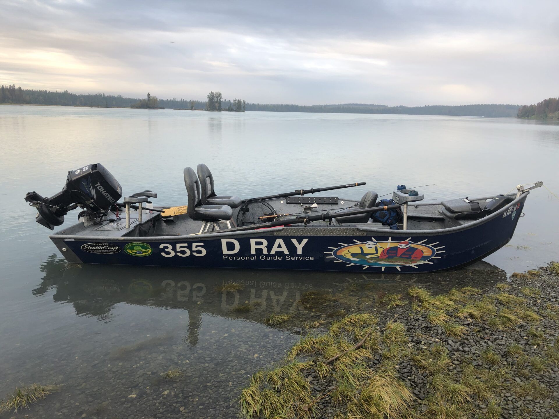 A dark blue aluminum fishing boat with the text 