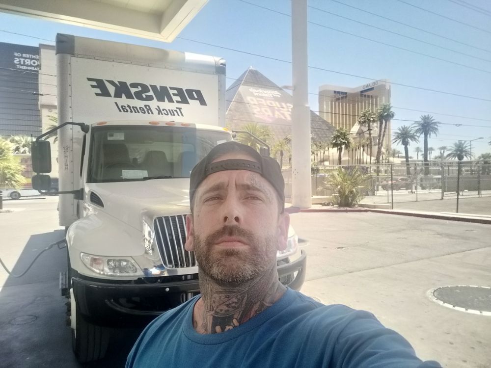 Owner Daniel Willis speaking with a residential customer beside a Willis Cargo Moving Company truck in Citrus Heights CA.