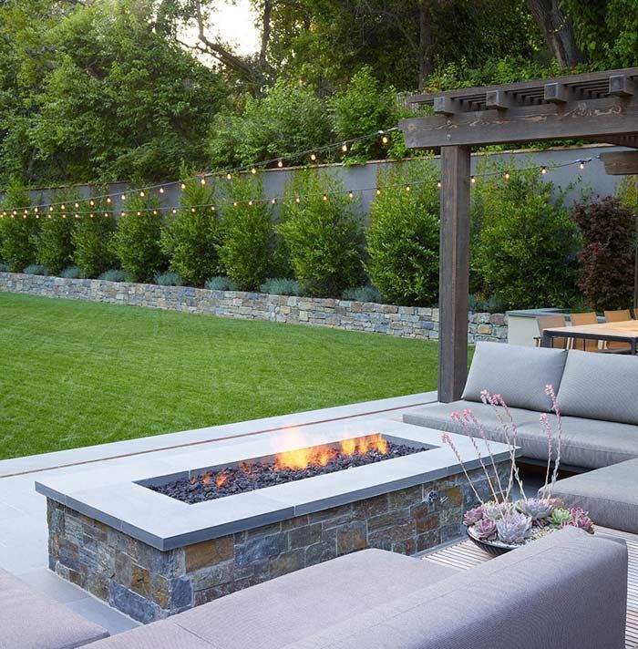 Outdoor firepit and paved seating area shown as patio design inspiration
