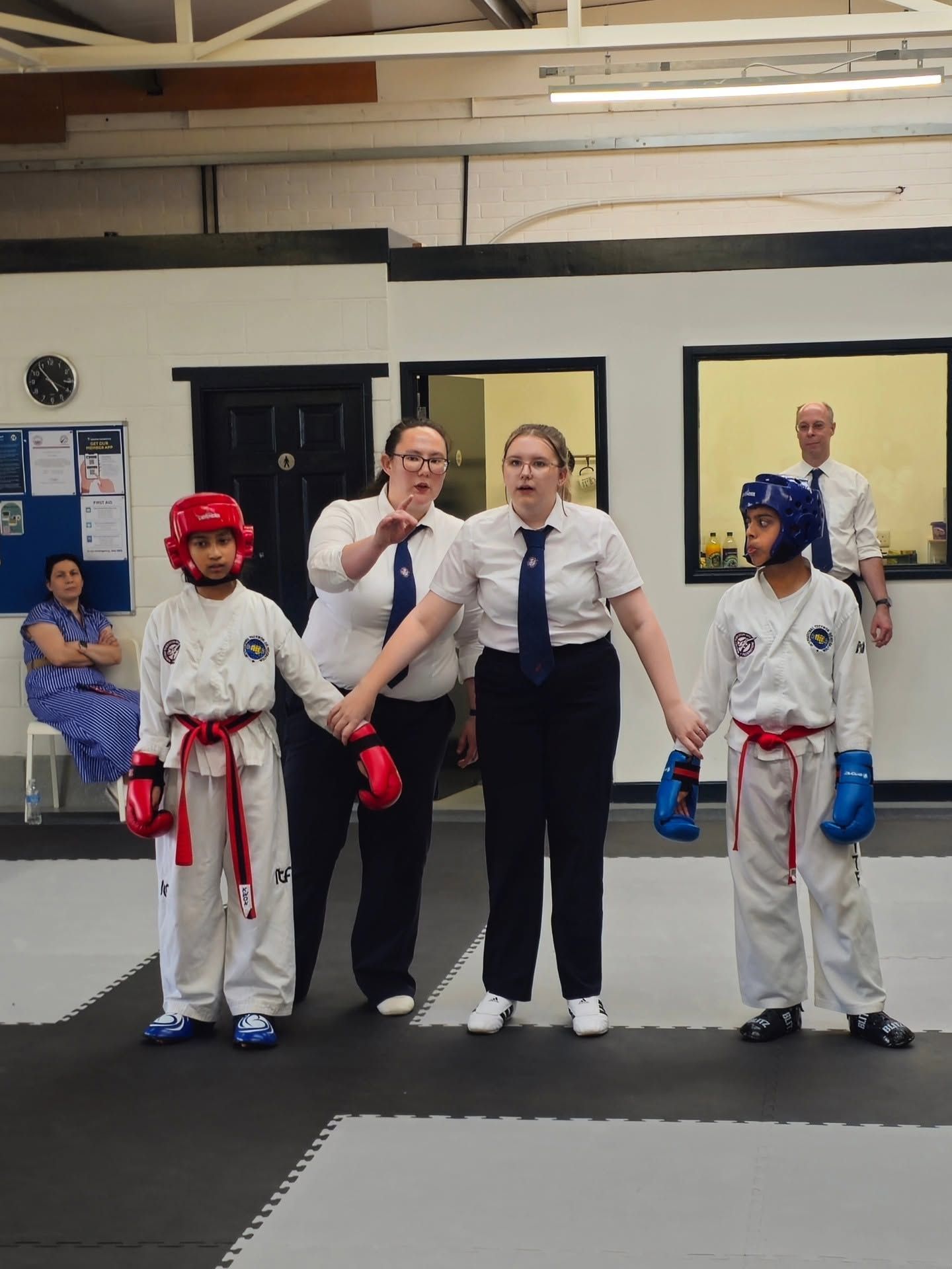 Umpire holding two Taekwon-Do students' hands