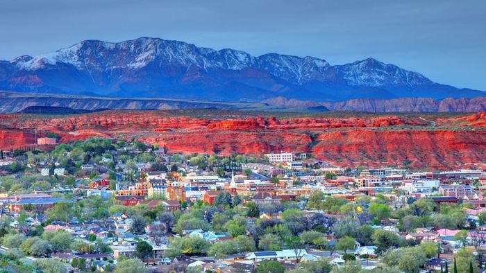 An aerial view of a city with mountains in the background.