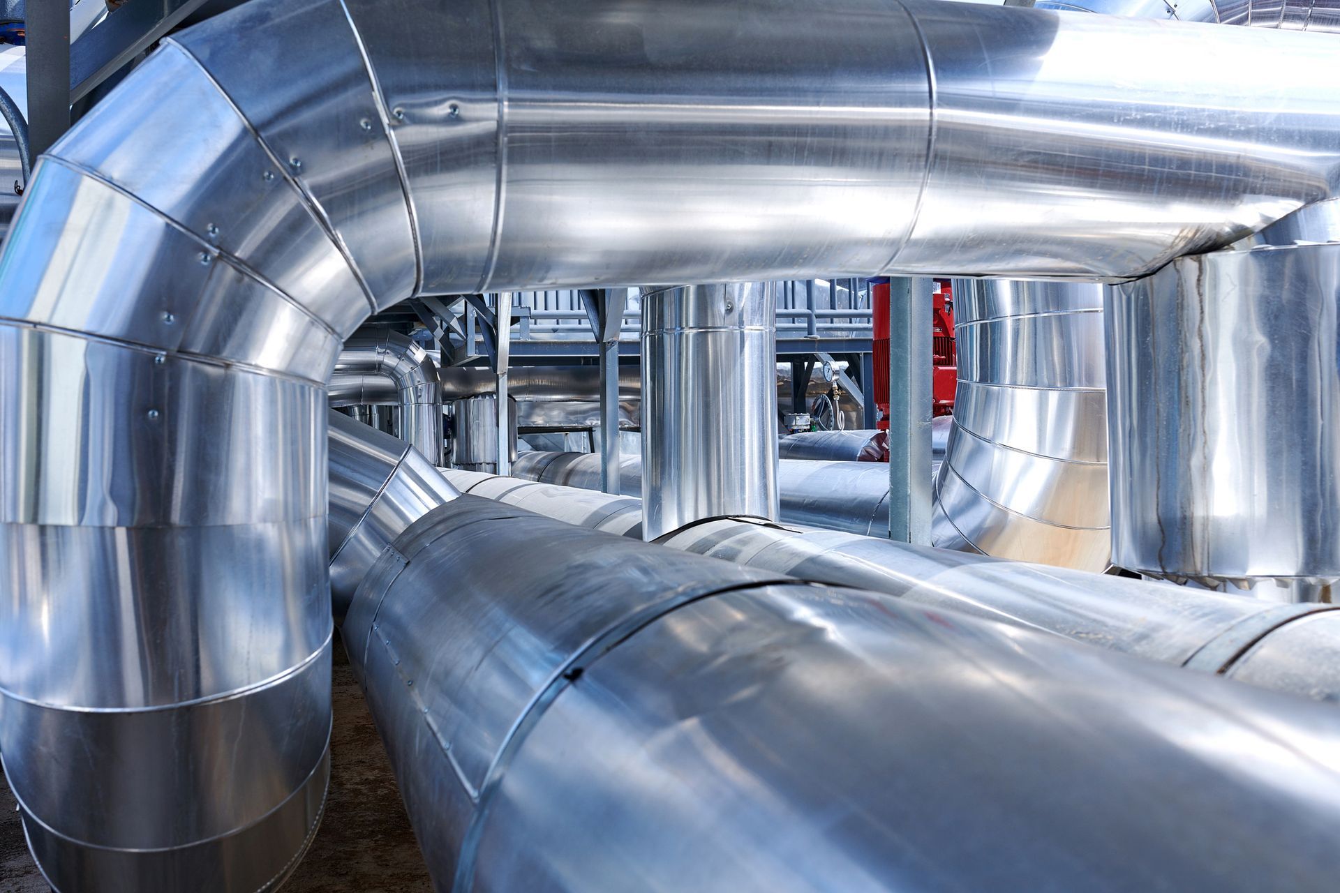 A Bunch of Metal Pipes Are Lined up In a Factory — Cinnaminson, NJ — MD Plumbing