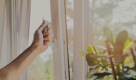 Hand opening a double-glazed window