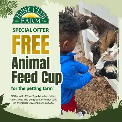 Hunters Club Farm special offer: free animal feed cup; child feeding goats at petting zoo