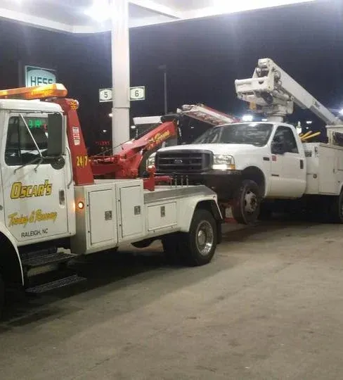 Two tow trucks are parked next to each other in a parking lot