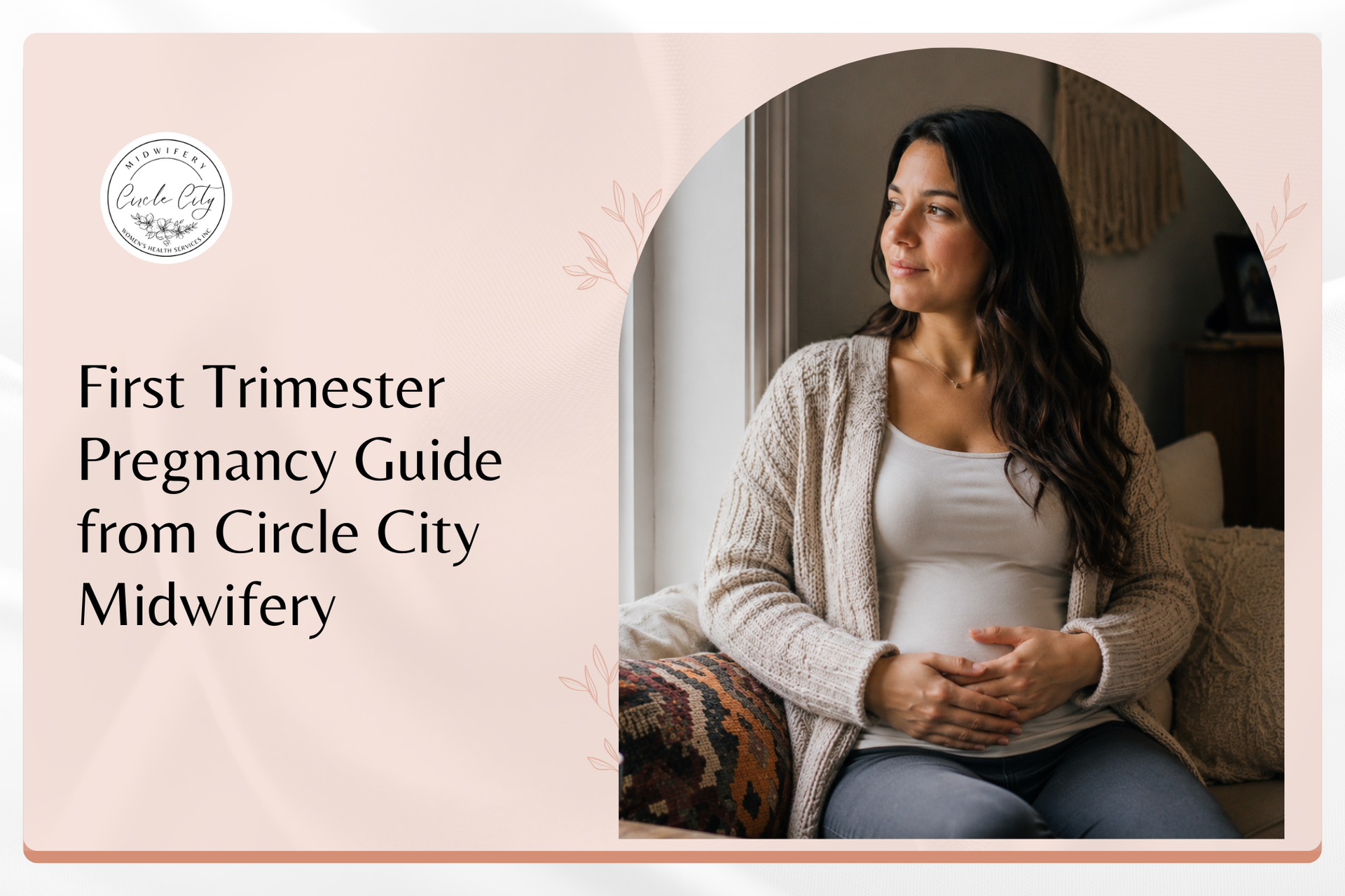 A woman rests her hand on her abdomen during the first trimester of pregnancy, looking calm and thou