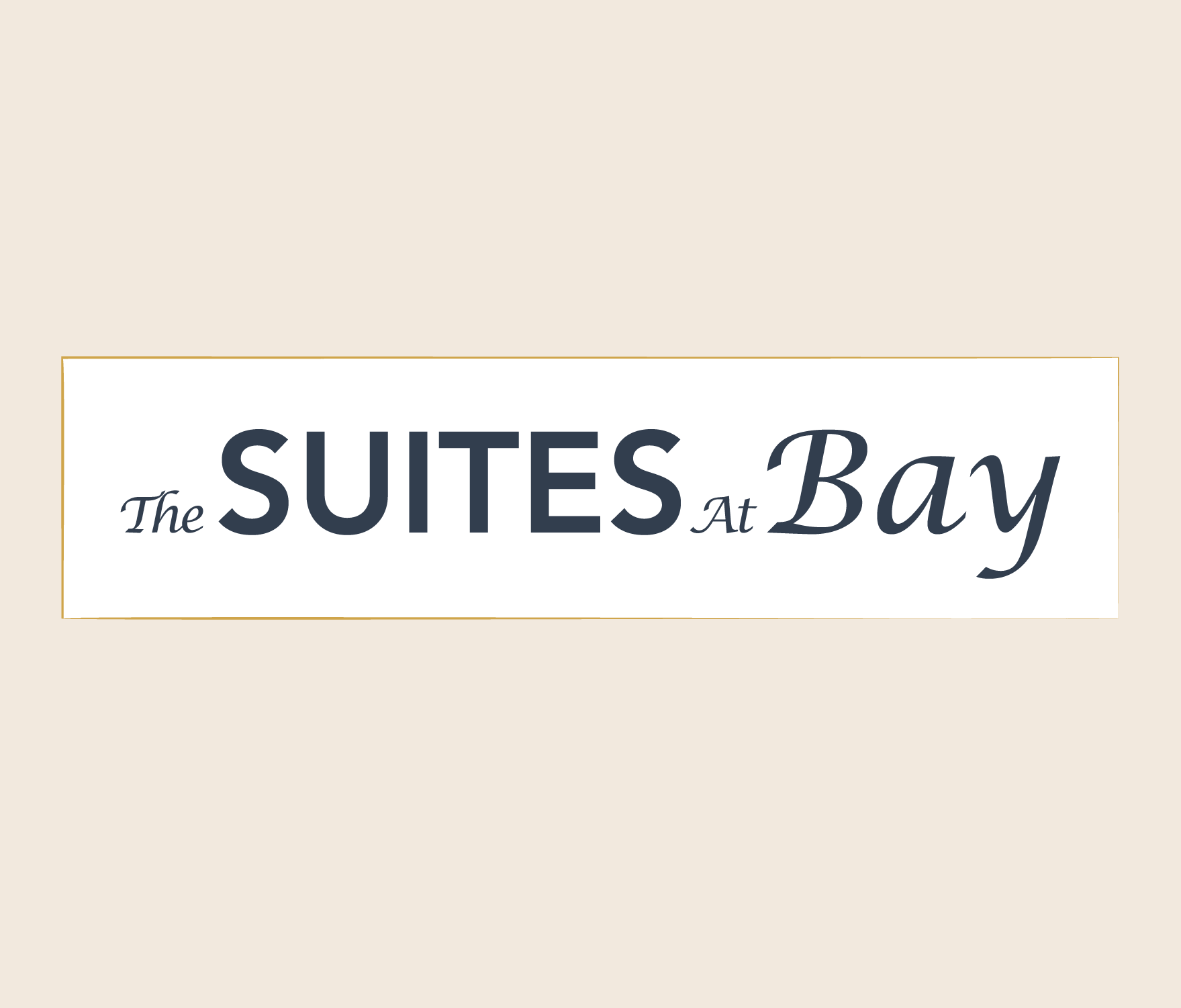 The Suites at Bay logo in dark blue letters, in a cream-colored rectangular box with a gold outline.