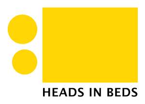 Yellow geometric logo with two circles and a square above the words “HEADS IN BEDS” hotel consultancy