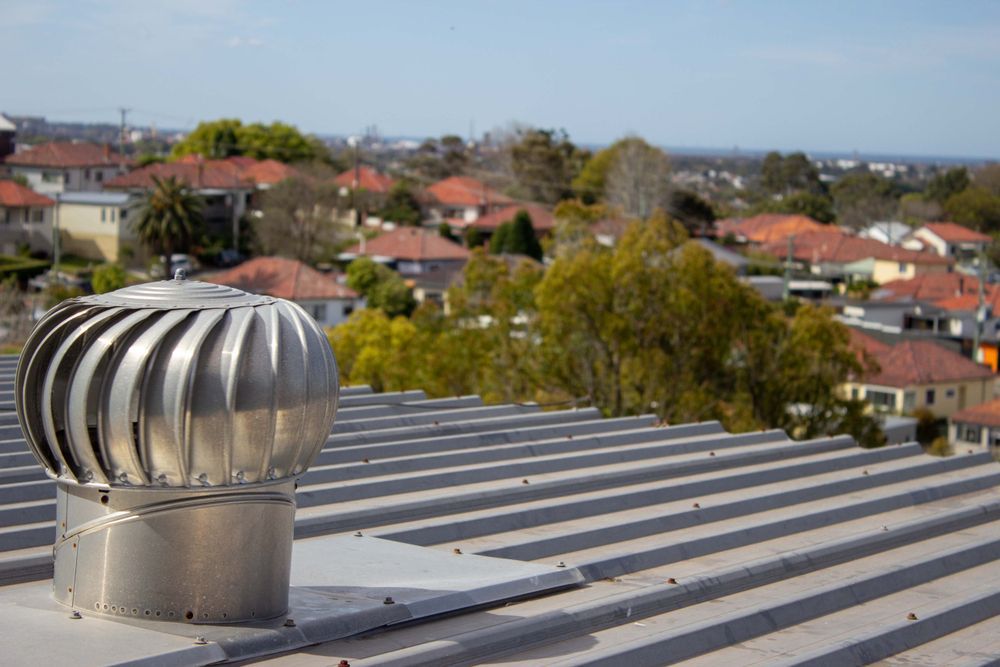 Metallic Roof Turbine on A Corrugated Metal Roof — Richmond Roof Tiling in Byron Bay, NSW