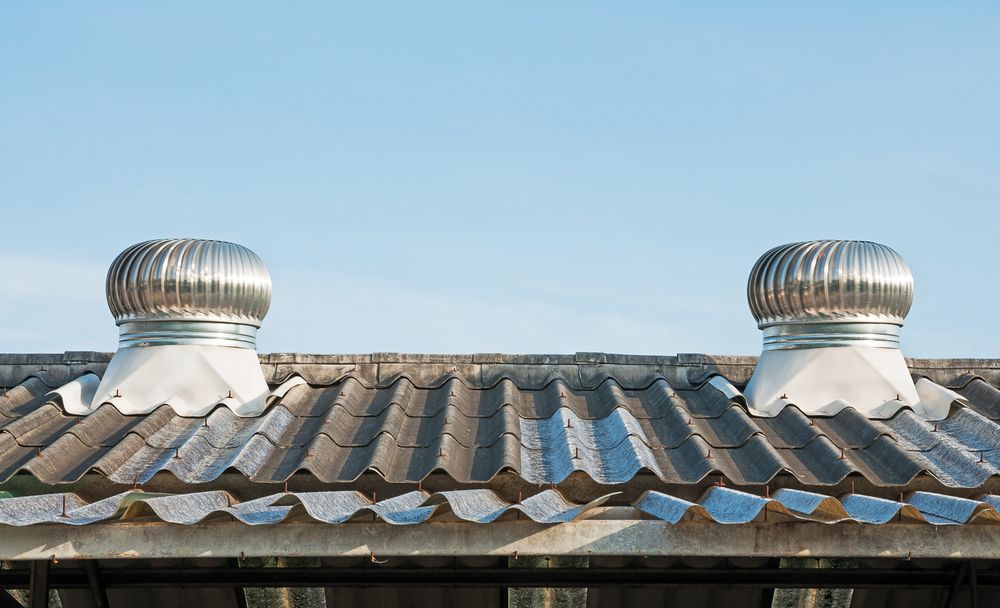 Two Silver Roof Vents on A Weathered Corrugated Roof — Richmond Roof Tiling in Lismore, NSW