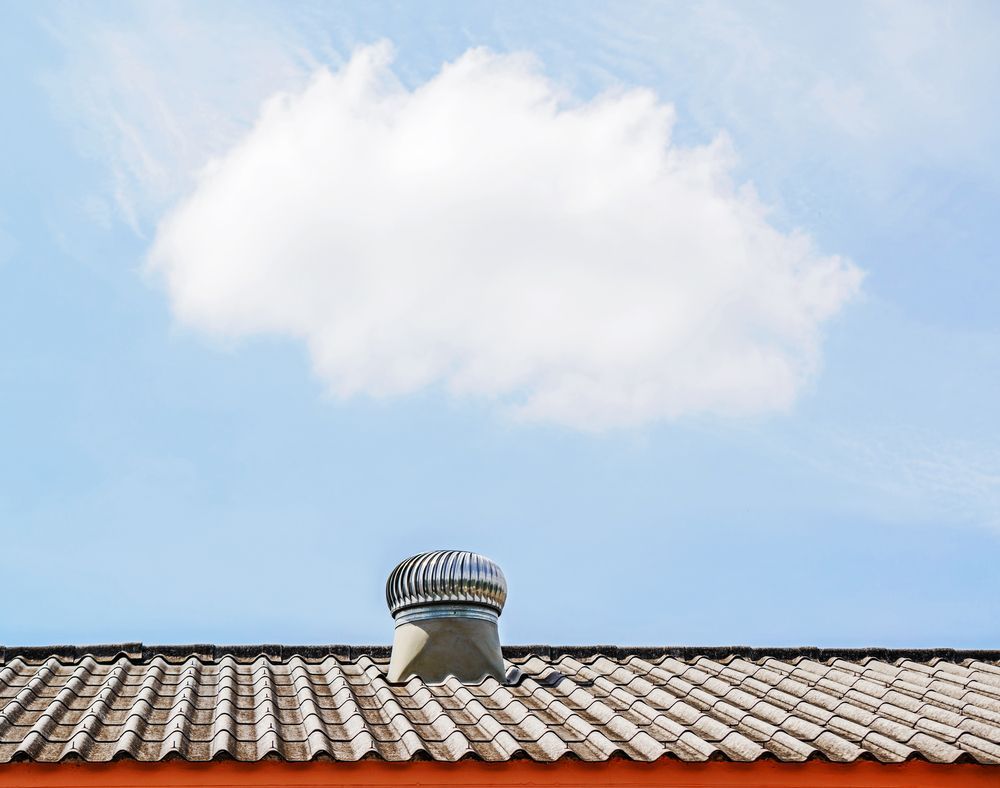 Roof with A Vent Under a White Cloud in A Blue Sky — Richmond Roof Tiling in Ballina, NSW