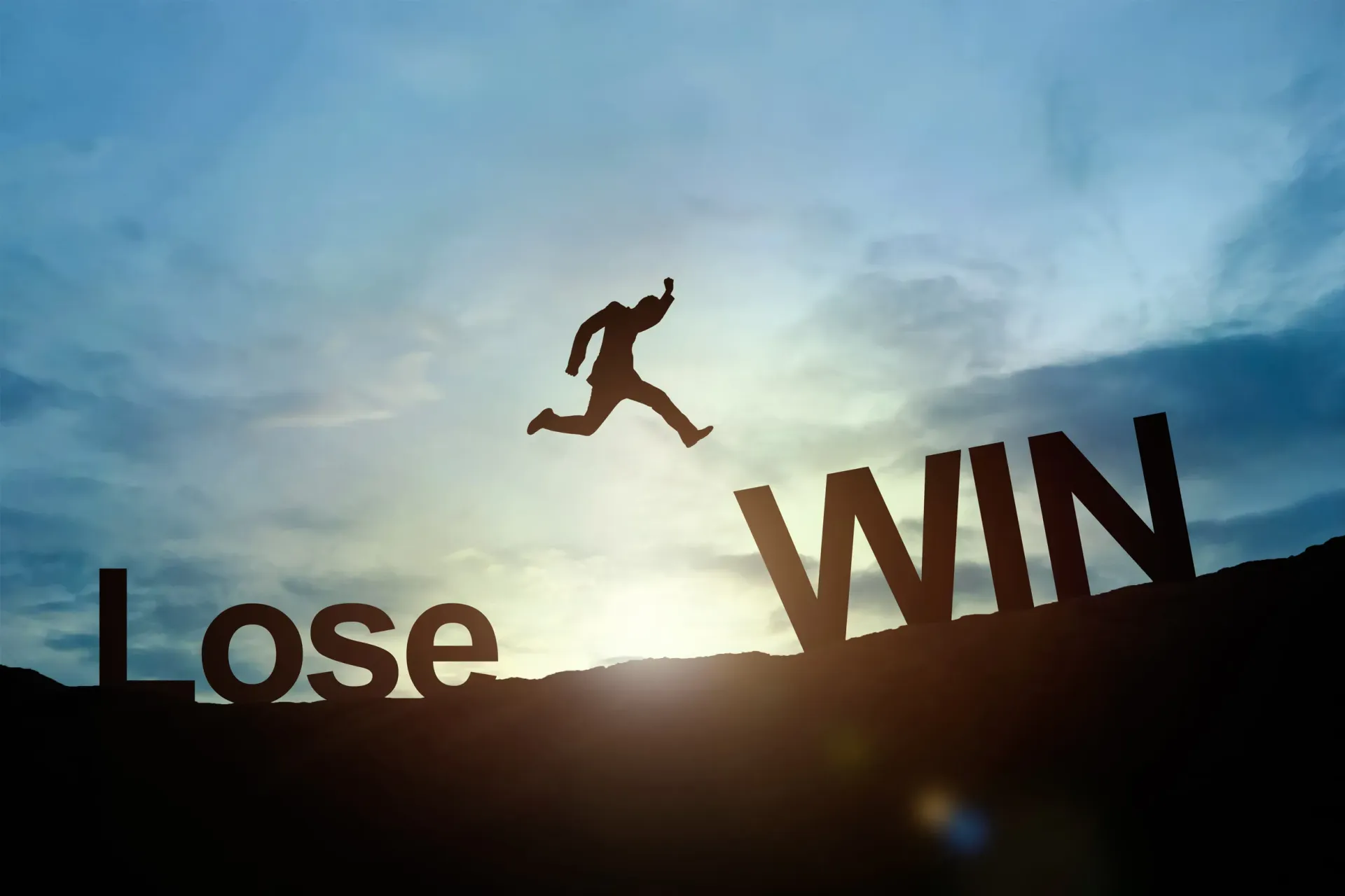 A man is jumping over the words lose and win.