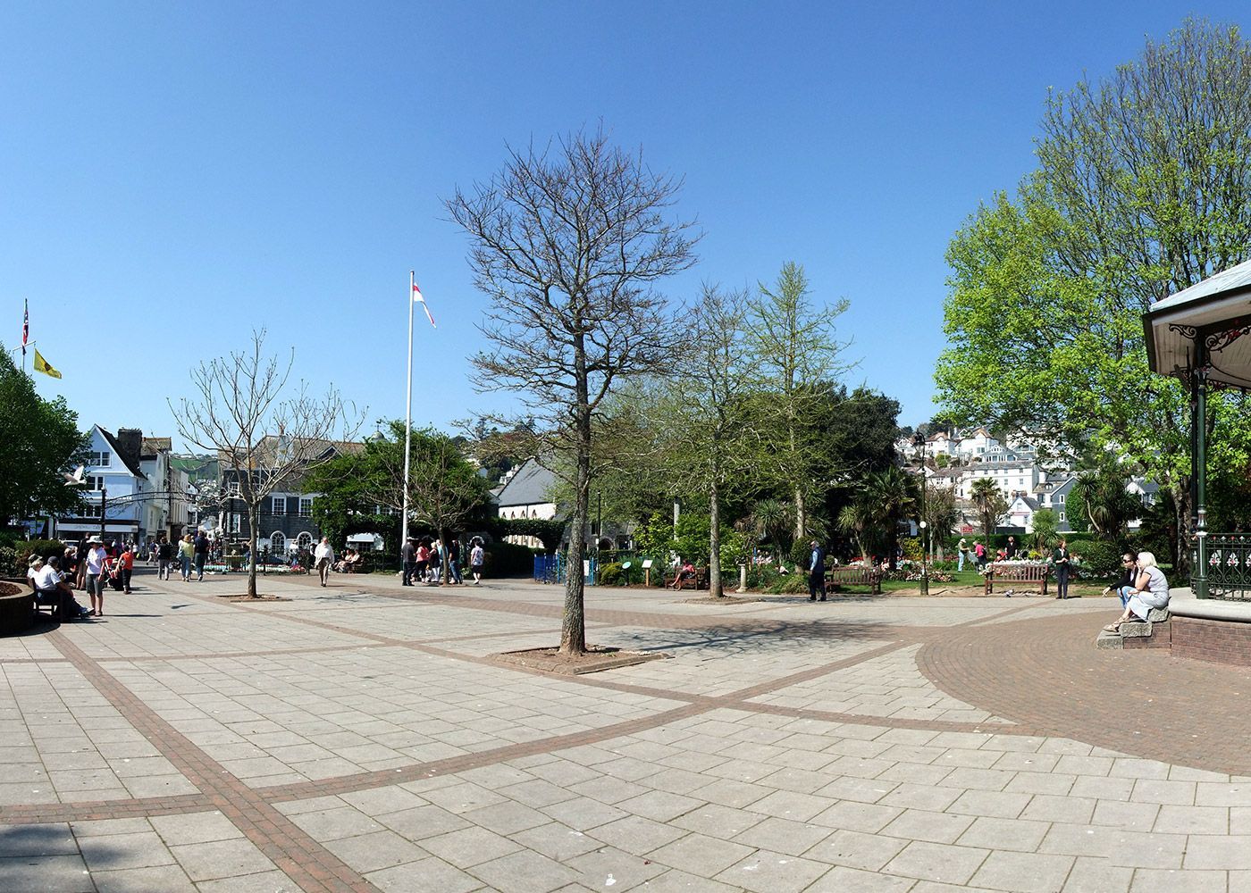A group of people are sitting on benches in a park