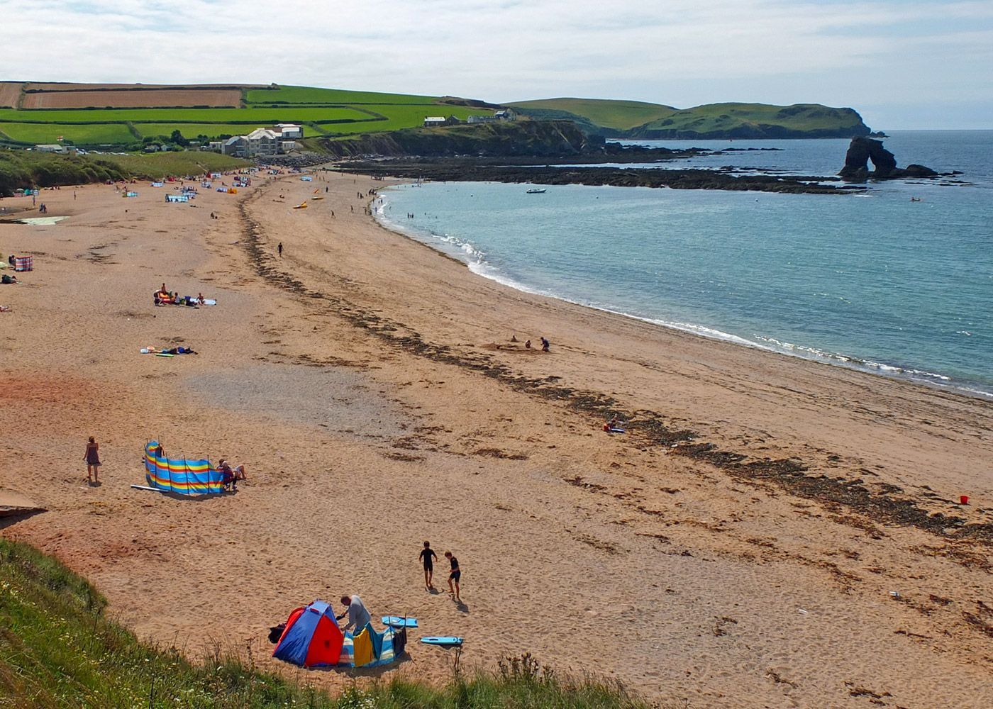 A beach with a red tent in the middle of it