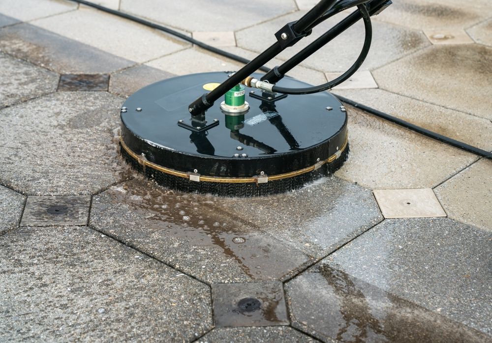 A machine is cleaning a tiled floor with a hose.