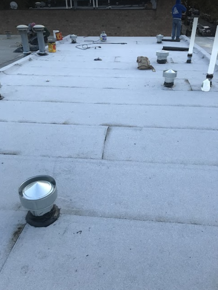 A white roof with a lot of vents on it