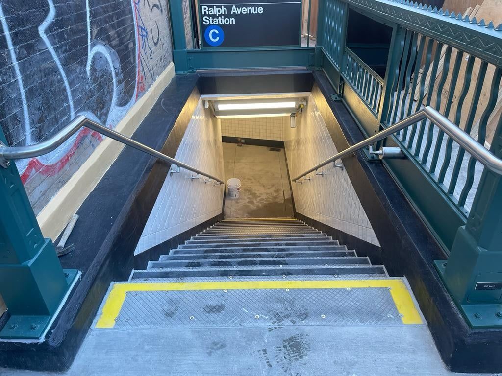 A set of stairs leading up to a subway station