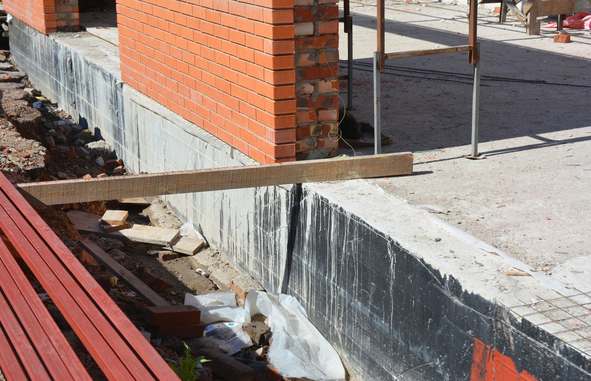 A brick wall is being built on a construction site
