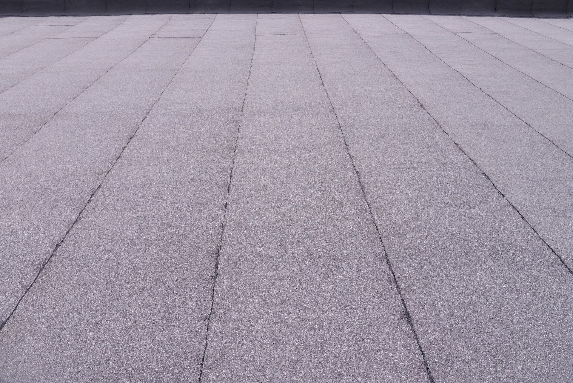 A close up of a gray tiled floor with a diagonal pattern.