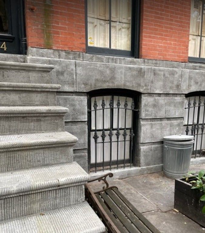A set of stairs leading up to a building with the number 4 on the door