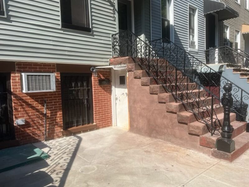 A brick building with stairs leading up to it.