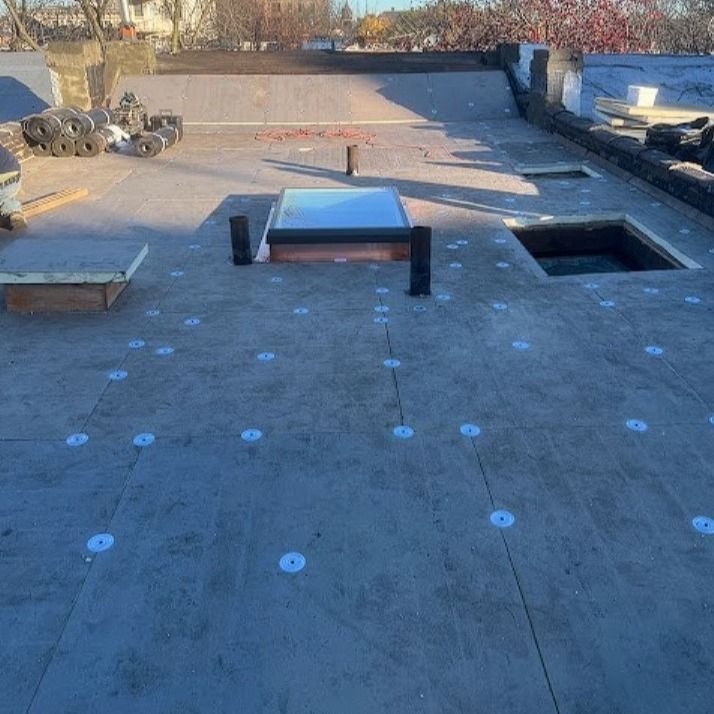 A roof with a skylight and a hole in it.