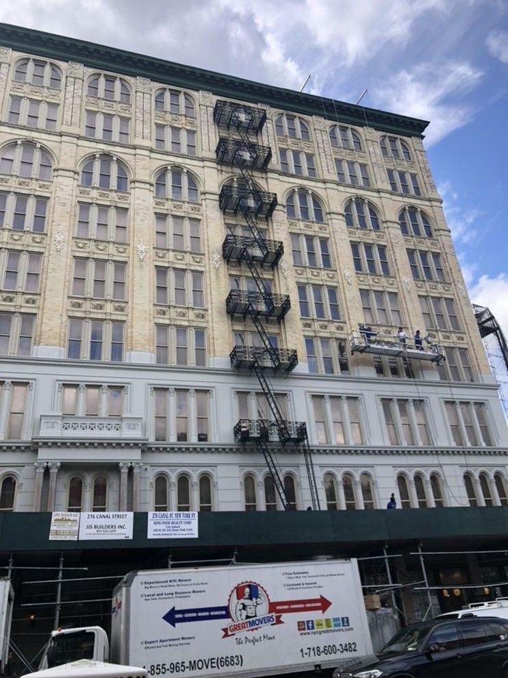 A large building with a fire escape on the side of it.