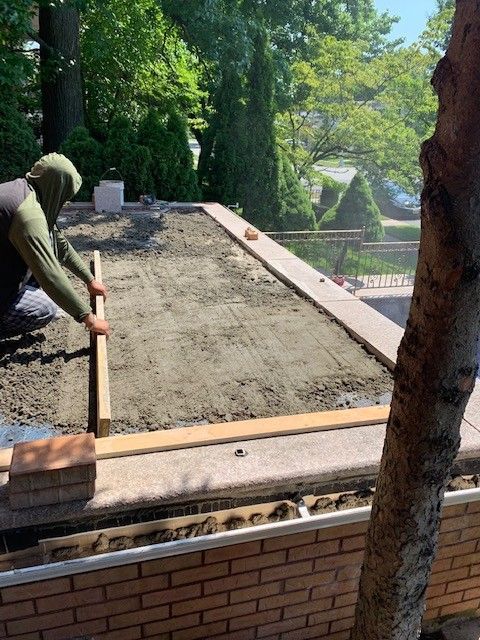 A man is working on a roof with a wooden ruler.