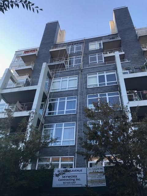 A tall building with a sign on the side that says ' simpson ' on it