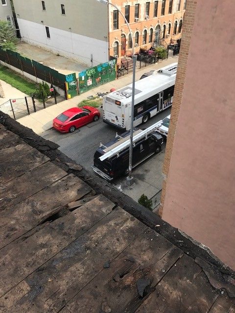 A view of a city street from the roof of a building