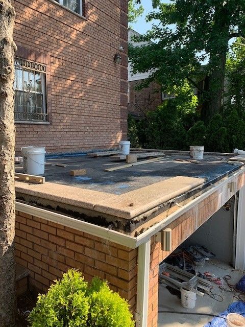 A brick house with a roof that is being remodeled