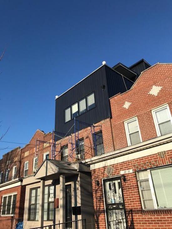 A row of brick buildings with a blue sky in the background.