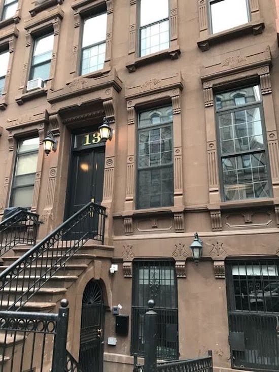 A brown building with the number 18 on the door
