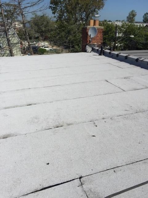 A roof with a chimney and satellite dish on it