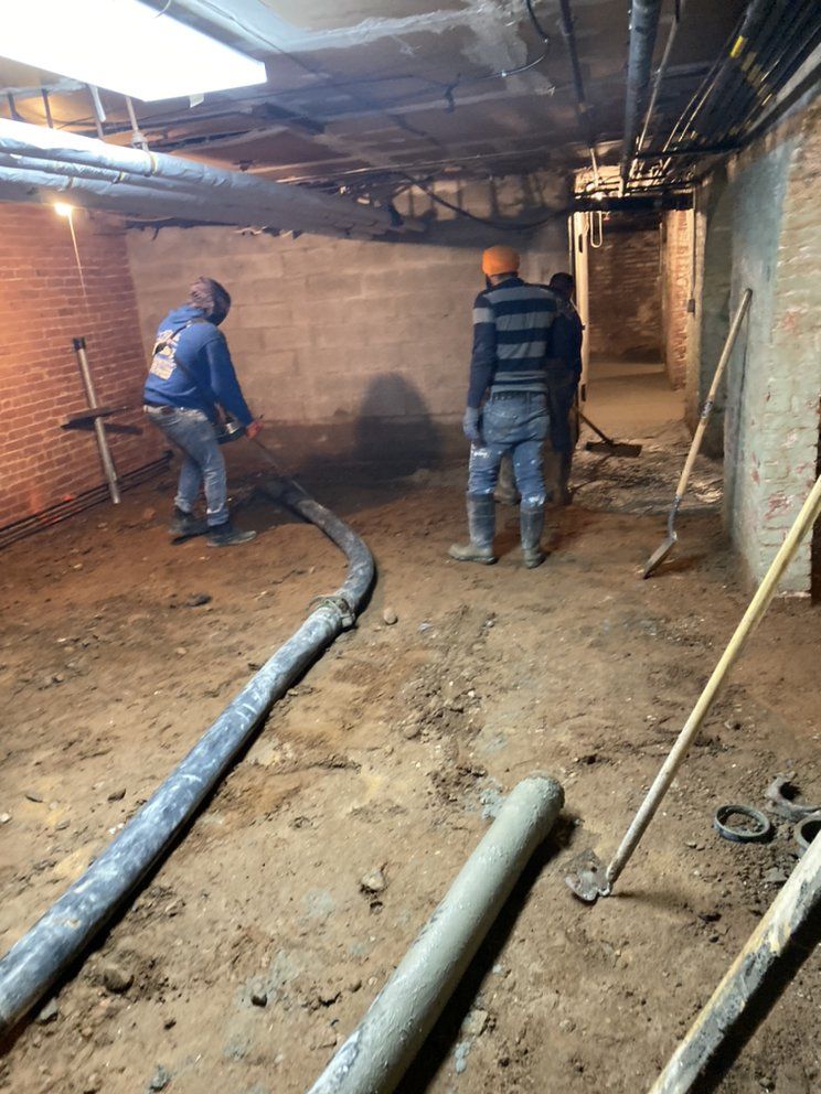 A group of men are working in a basement.