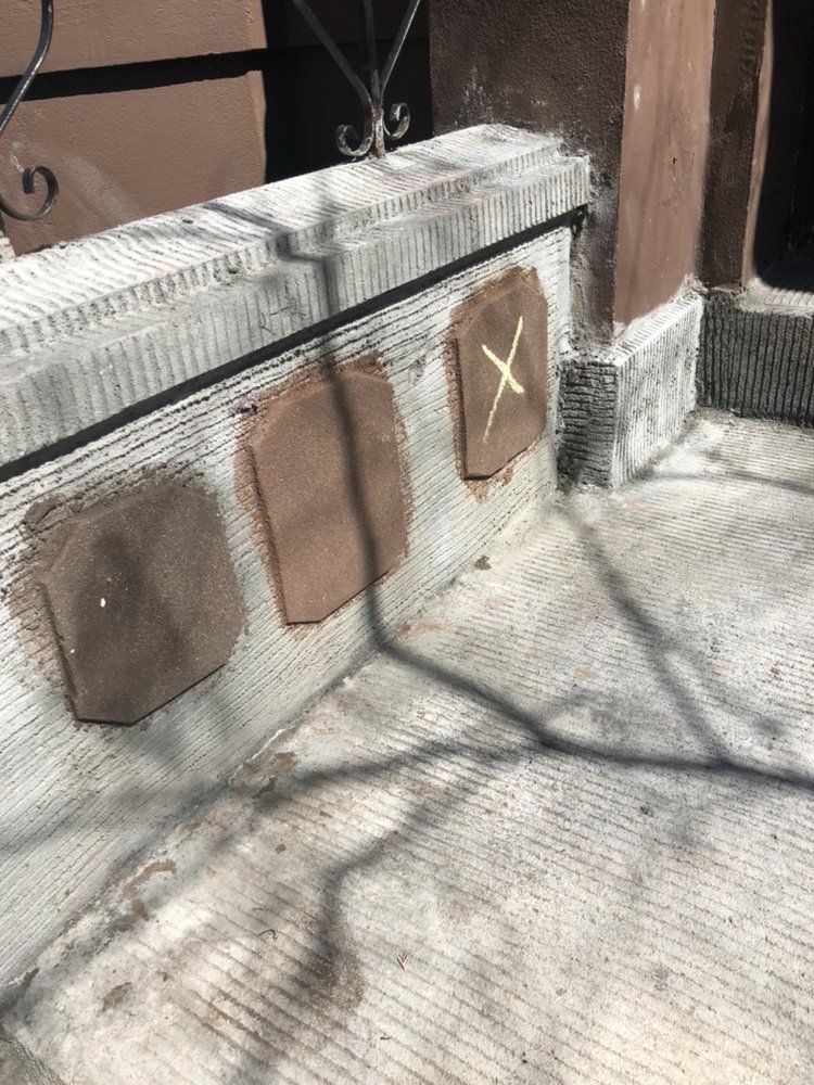 A row of tiles sitting on top of a concrete wall.