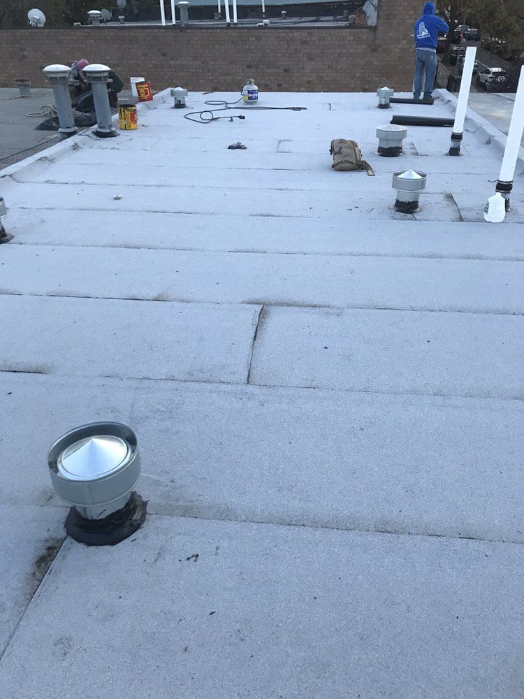A white roof with a lot of vents on it